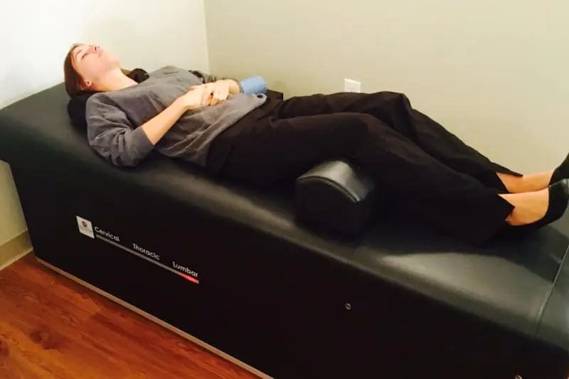 Roller table with patient receiving chiropractic treatment